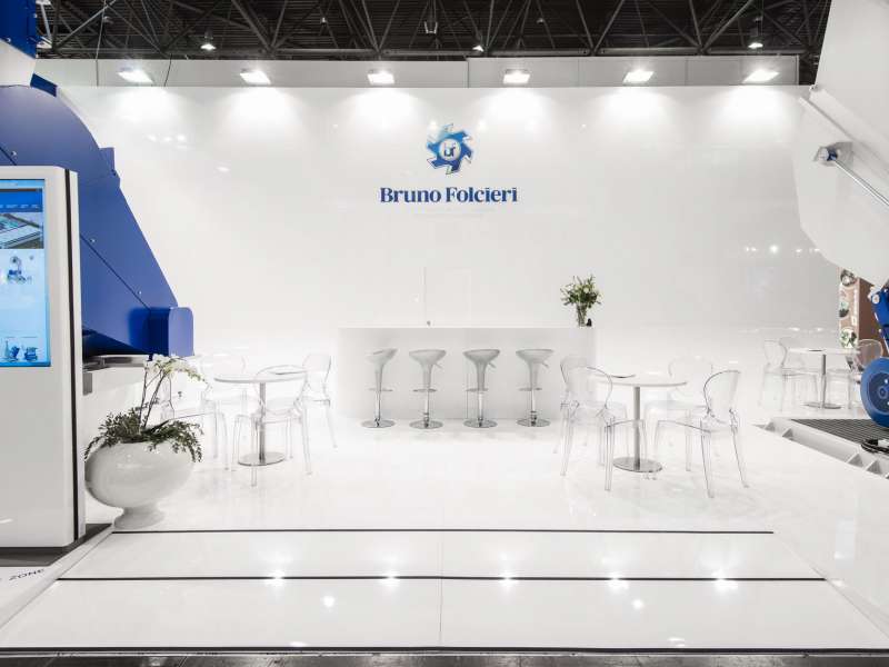 exhibitors' furniture and customized tables, highly customized solutions, videowall and interactive totem, lighting engineering, concept and design