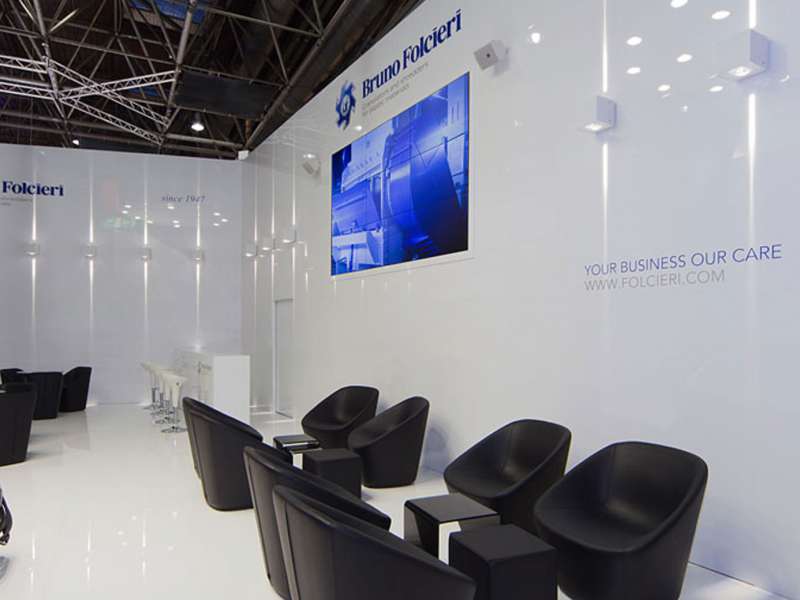 exhibitors' furniture and customized tables, highly customized solutions, videowall and interactive totem, lighting engineering, concept and design