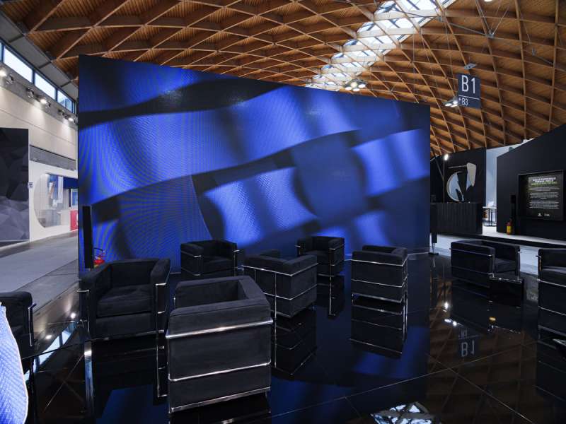 exhibitors' furniture and customized tables, videowall and interactive totem, lacquered stands, ledwall